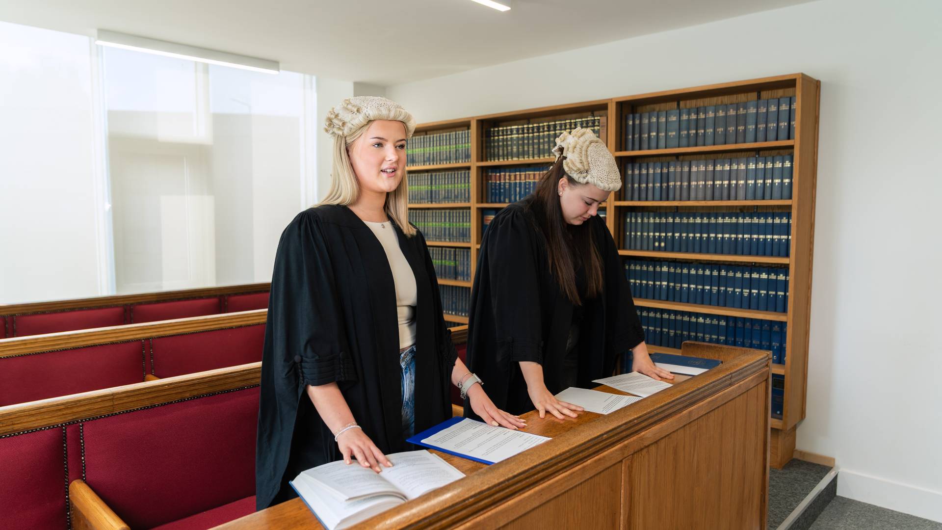 Two students in a practice court room.